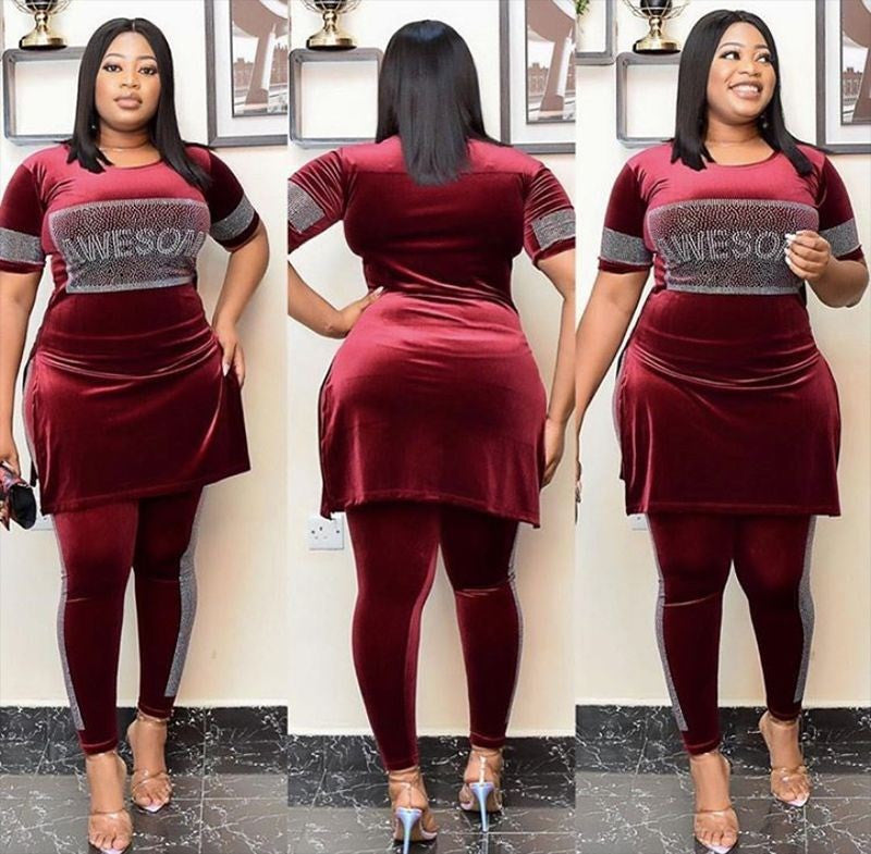 Woman wearing a burgundy African velvet two-piece skirt set