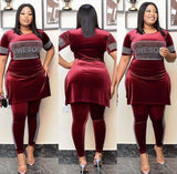 Woman wearing a burgundy African velvet two-piece skirt set