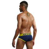 Man wearing red and black men's cotton low-rise briefs with a soft elastic waistband and supportive fit.