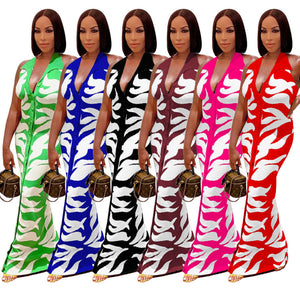 Woman wearing a pink and white printed backless bodycon maxi dress with a stylish, elegant design.