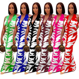 Woman wearing a pink and white printed backless bodycon maxi dress with a stylish, elegant design.