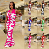 Woman wearing a pink and white printed backless bodycon maxi dress with a stylish, elegant design.