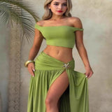 Woman wearing a green off-shoulder crop top and split maxi skirt two-piece set with a stylish summer look.