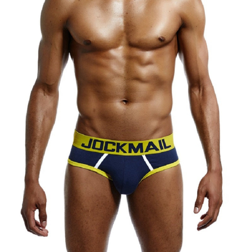 Man wearing red and black men's cotton low-rise briefs with a soft elastic waistband and supportive fit.