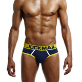 Man wearing red and black men's cotton low-rise briefs with a soft elastic waistband and supportive fit.